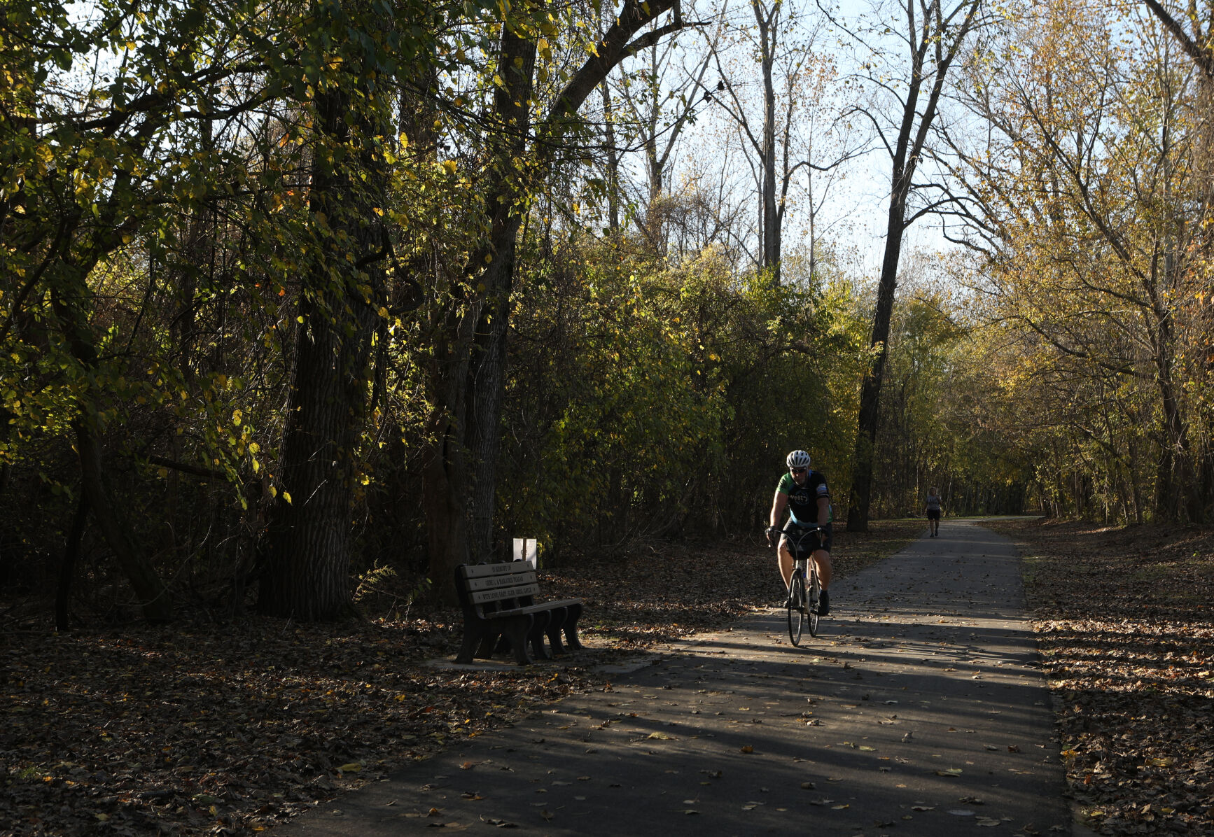 A bicyclist rides on the trail